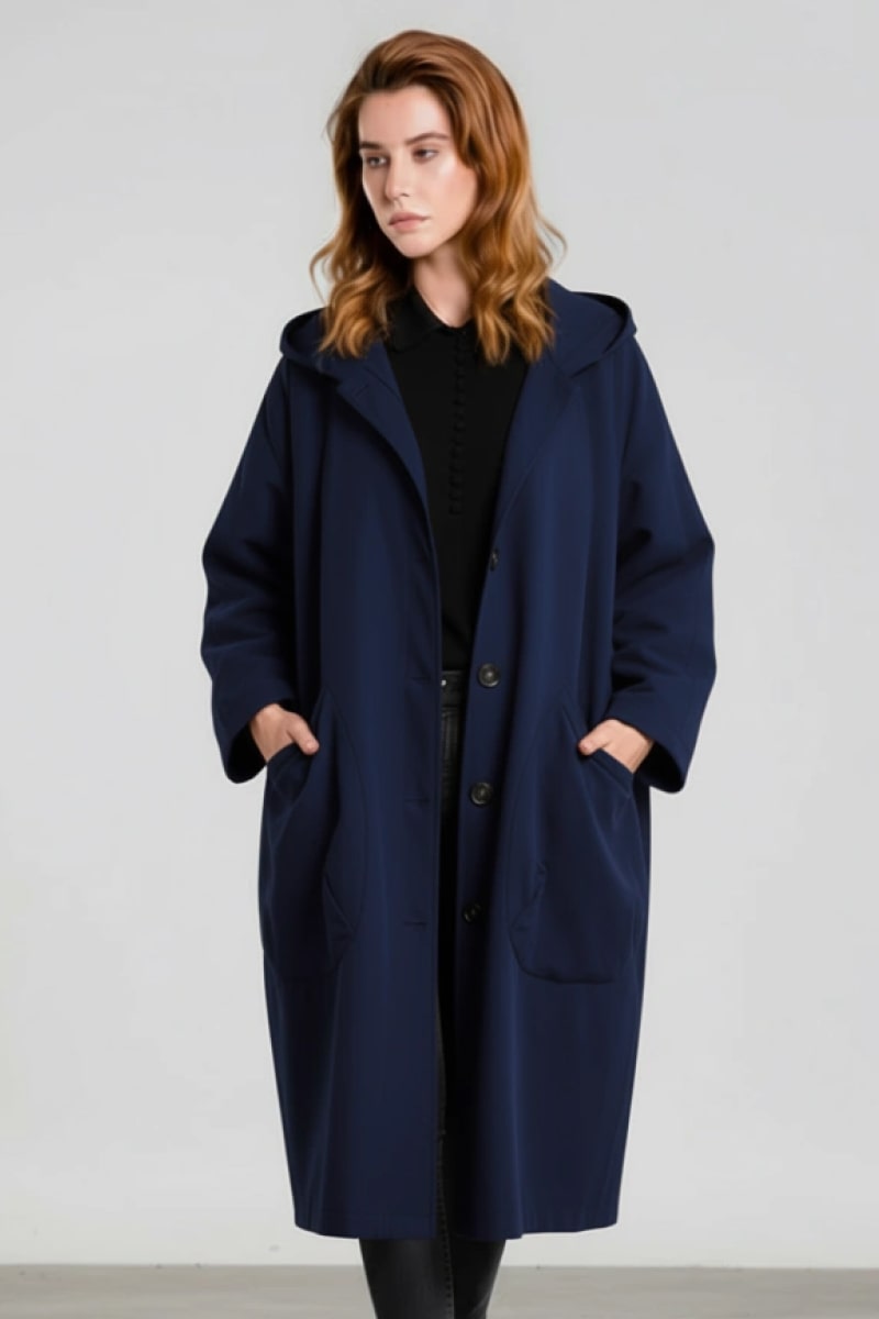 A person models the looselyboho Navy Blue One Size Fits All Oversized Water Resistant Windbreaker Jacket, standing with hands in pockets against a plain light background.