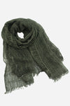 An olive green, lightweight scarf is intricately woven with a subtle ribbed texture. The ends are frayed, giving it a casual, rustic appearance. Crafted from ultra-breathable linen, this versatile clothing piece is draped in a loose roll, showcasing its airy and soft fabric against a plain white background. This is the Lightweight Linen Scarf by looselyboho.