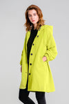 A person with shoulder-length light brown hair models the looselyboho SUNLIT YELLOW WINDBREAKER, featuring black buttons, over a black outfit against a plain light grey background.