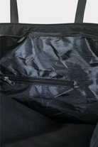 Close-up of the Urban Slate Waterproof Bag’s interior, featuring a small zippered pocket on the lining and two black top handles—ideal for gym sessions or travel.